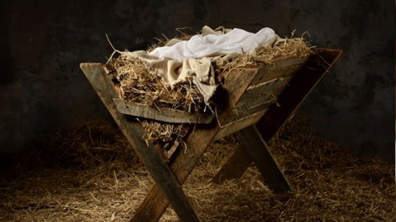 Manger with hay and swaddling clothes in old stable