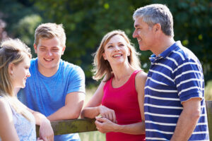 Family With Teenage Children Walking In Countryside A happy family with teenage children.