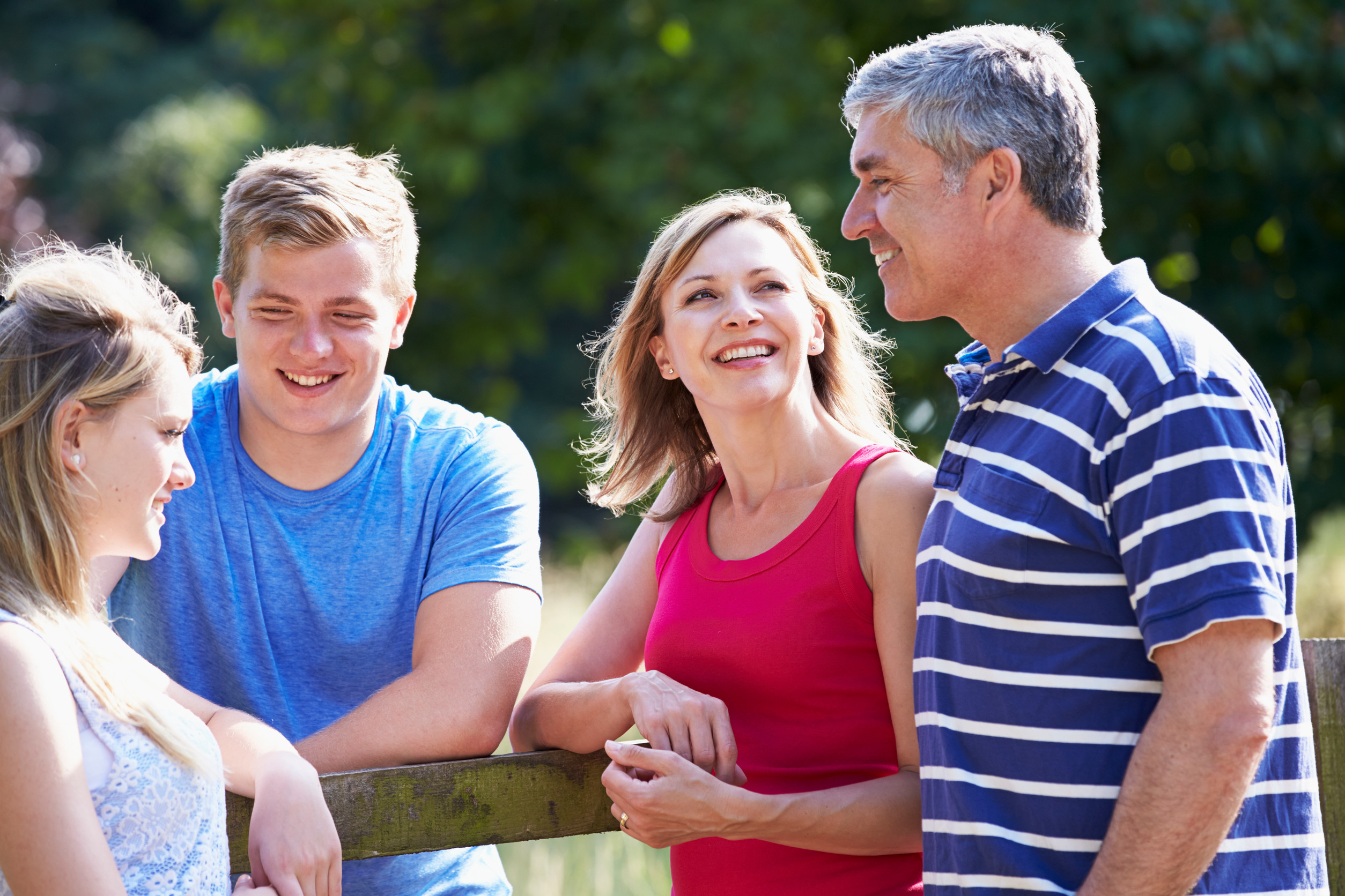 A happy family with teenage children.