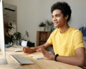 A teenage boy working on a desktop.