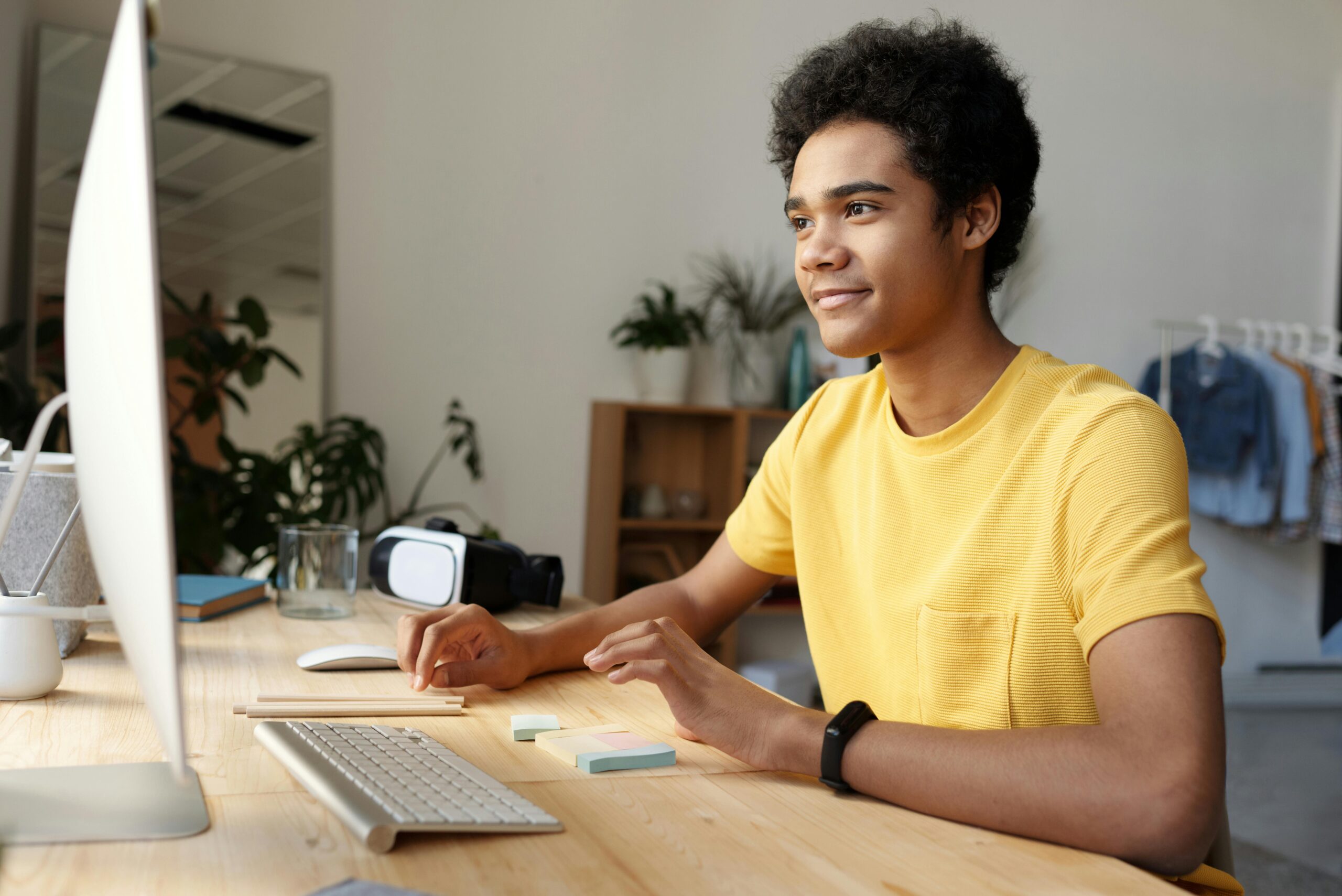 A teenage boy working on a desktop.