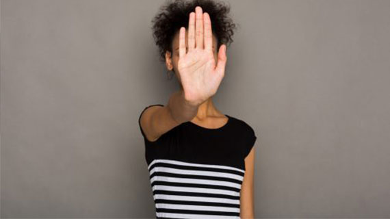 Young african-american woman covering her face with palm saying no