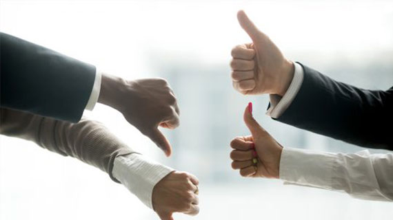 Hands Of Diverse Business People Showing Thumbs Up And Down