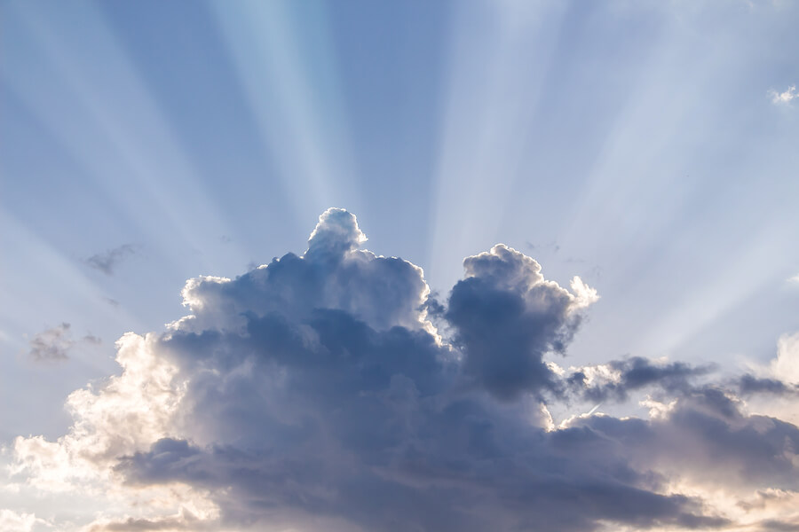 Sun beams or light rays breaking through the clouds