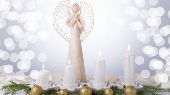 A white angel and four white Advent candles