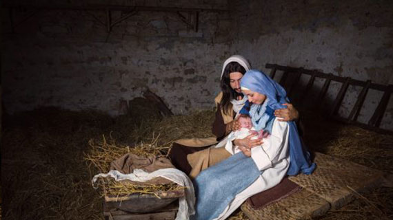 Live Christmas nativity scene in an old barn