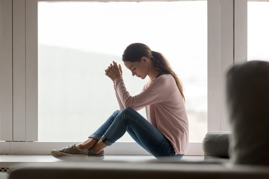Unhappy Young Woman Sit On Windowsill Thinking