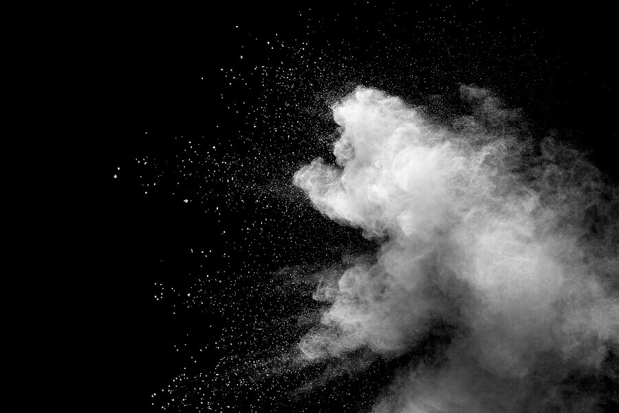 Explosion of white dust on black background