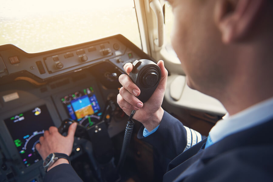Close Up Pilot Hand Taking By Portable Radio Set In Cabin While