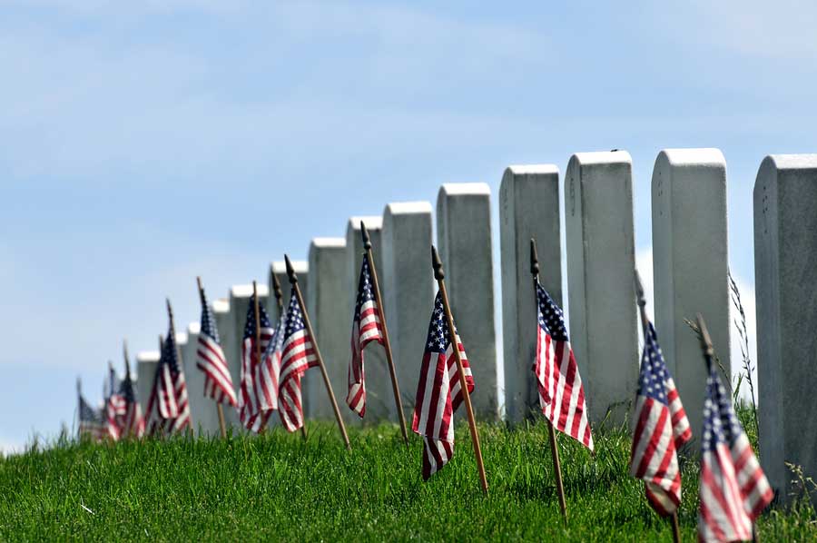 Gravestones decorated with U.S. flags to commemorate Memorial Da