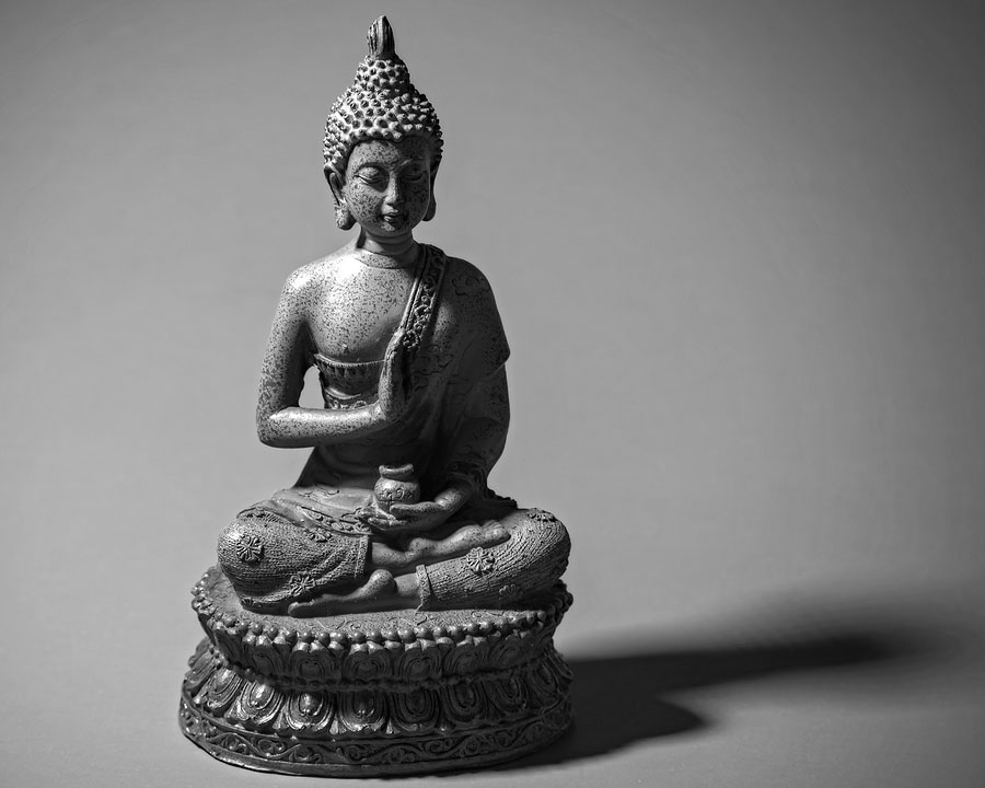 Zen Buddah Statue Casting A Shadow In Light
