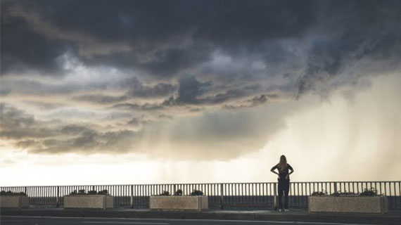 A girl watching spectacular storm in Italy