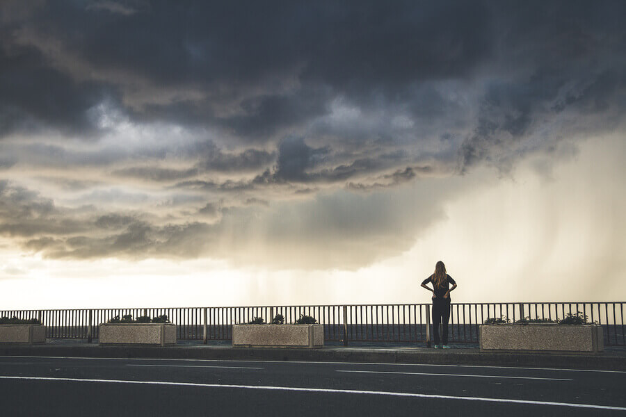 A girl watching spectacular storm in Italy