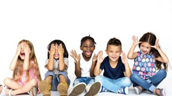 Diverse group of children doing peek a boo hand gesture