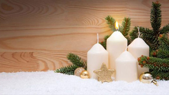 White burning candle for the first advent